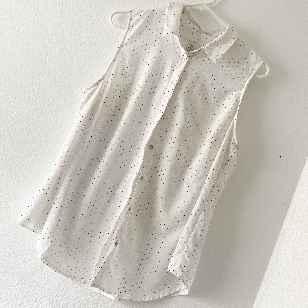 White and black polka dot sleeveless shirt